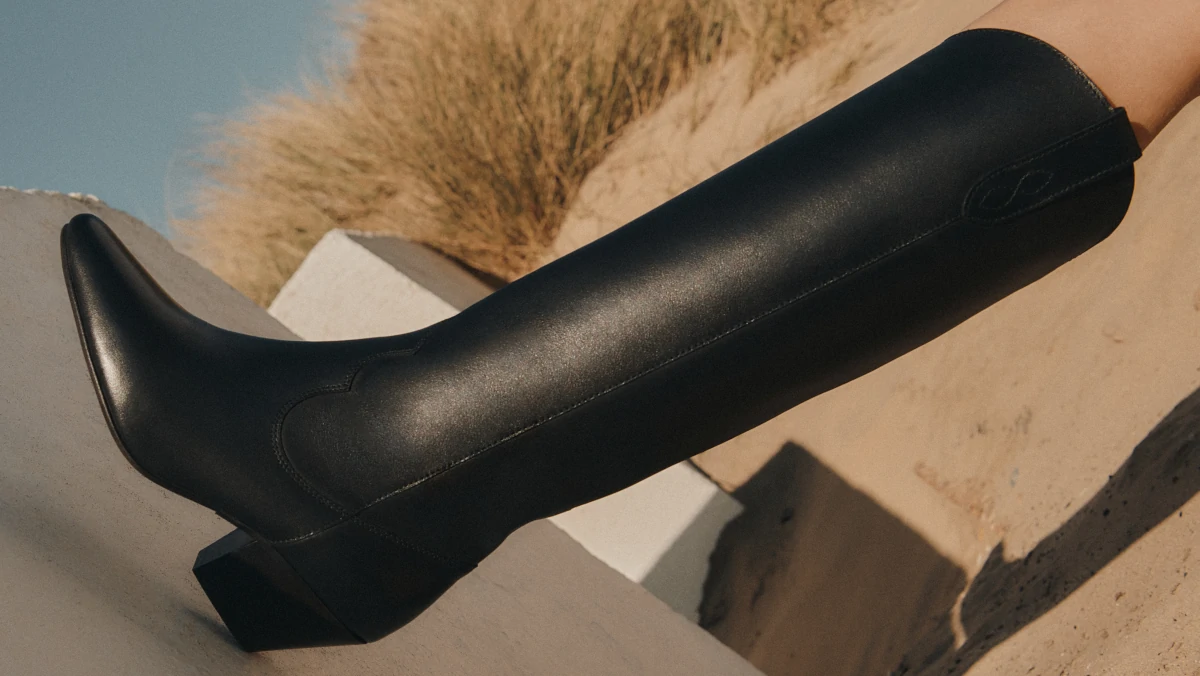 A close up image of a single black leather fashion boot with heel to showcase Fox Collective's Fashion PR expertise